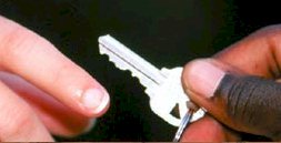 hands being handed a key